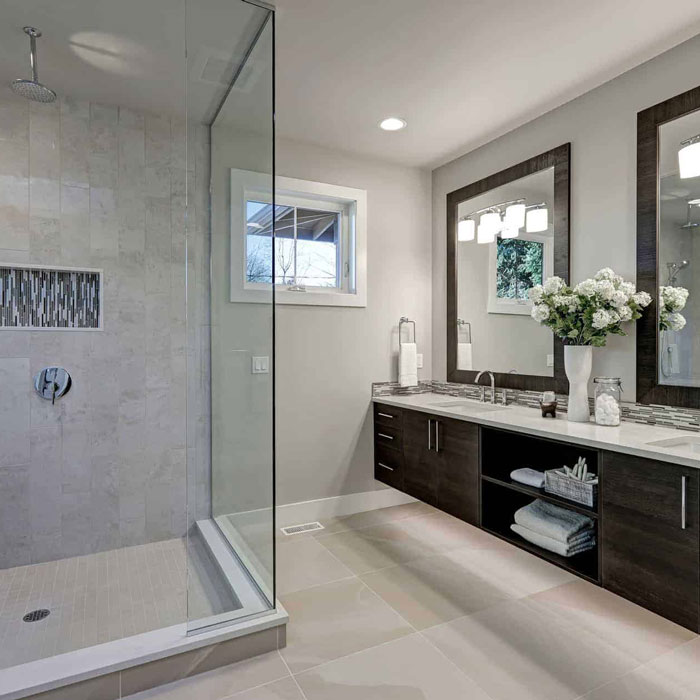modern bathroom interior with walk-in shower featuring glass pane walls as well as dual sink vanity with individual mirrors from Blossom Hill Glass in San Jose, CA