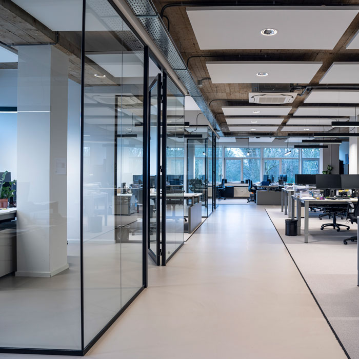 modern office interior featuring large glass panels as room dividers