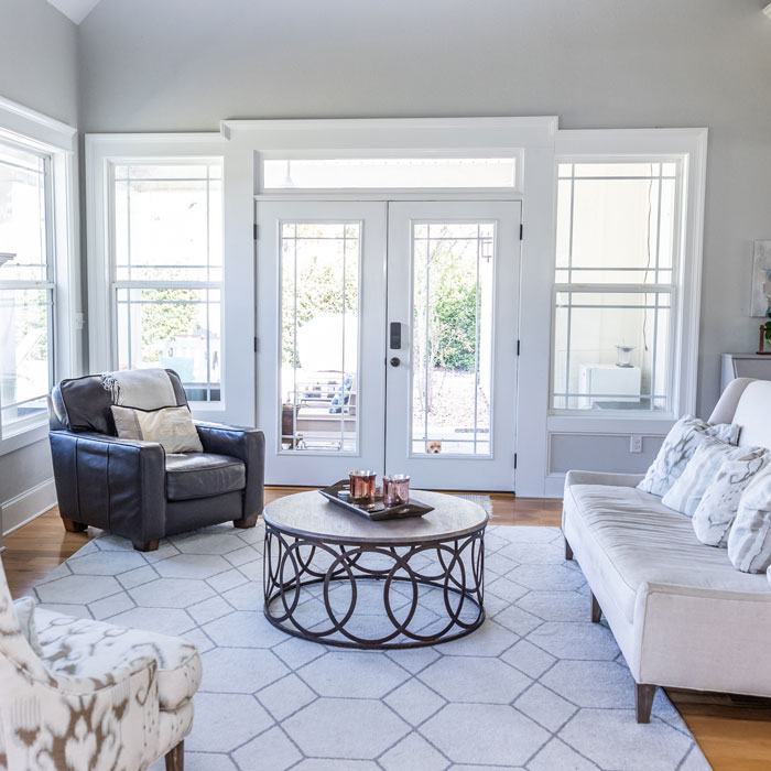 Interior of modern home featuring large glass windows and french doors